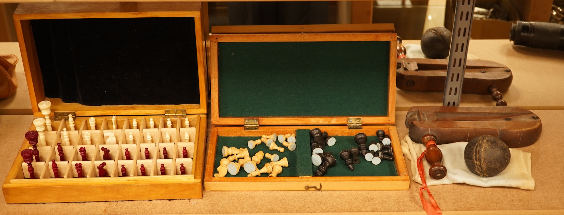 Two boxed chess sets, a cricket ball and a bird scaring rattle, largest chess set 32cm wide x 9cm high x 20cm deep.